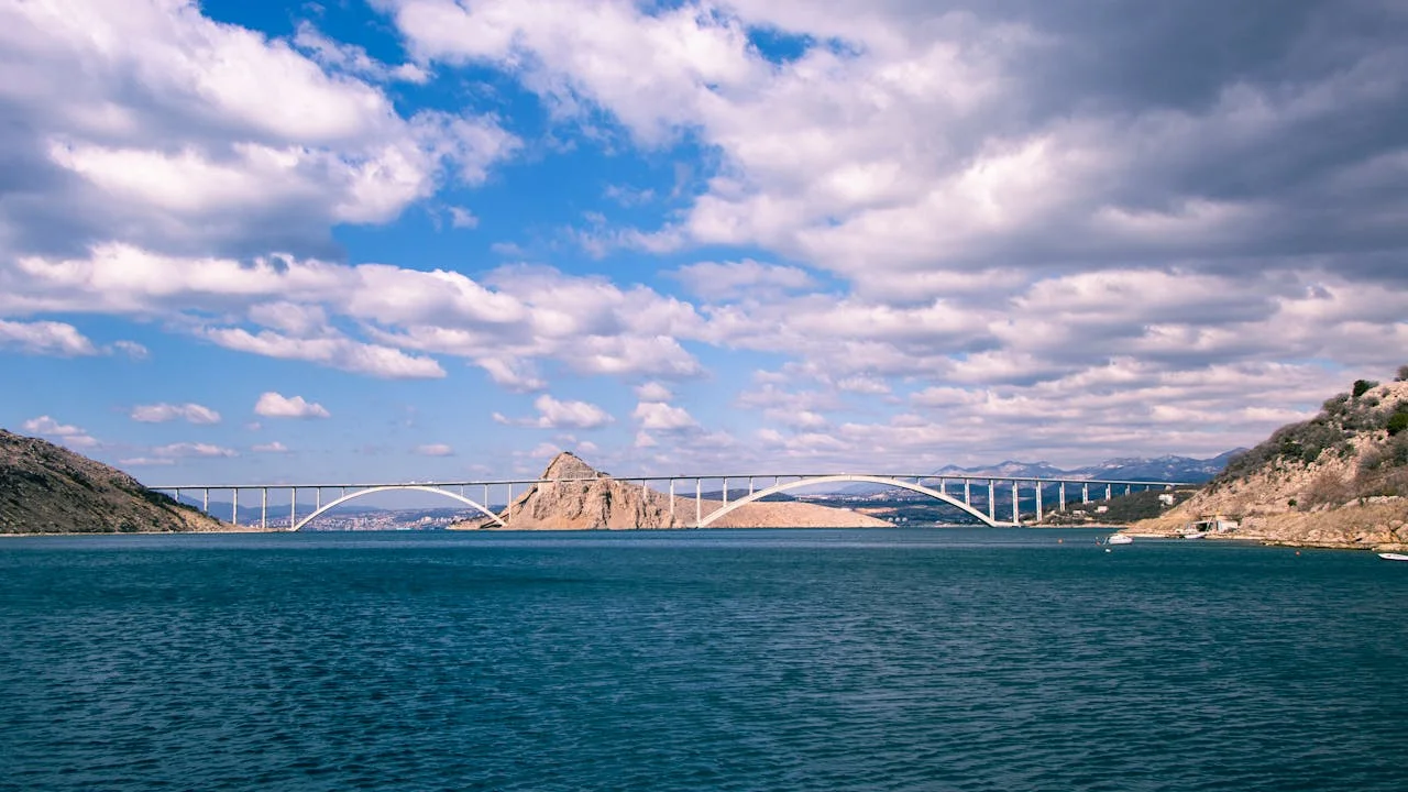 Krk Bridge near Rijeka, Croatia, spans the blue sea amidst rugged coastlines